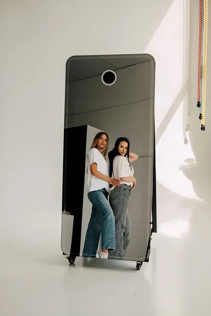 Two guests photographed full length in the PicMe magic mirror booth