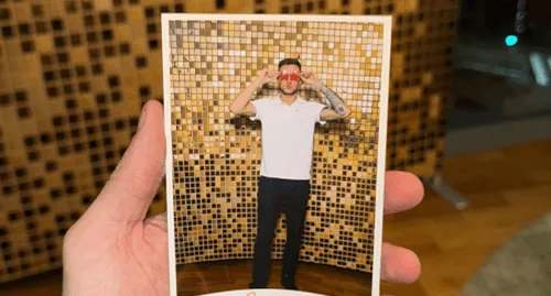 Printed photo strip from a photo booth held in a hand