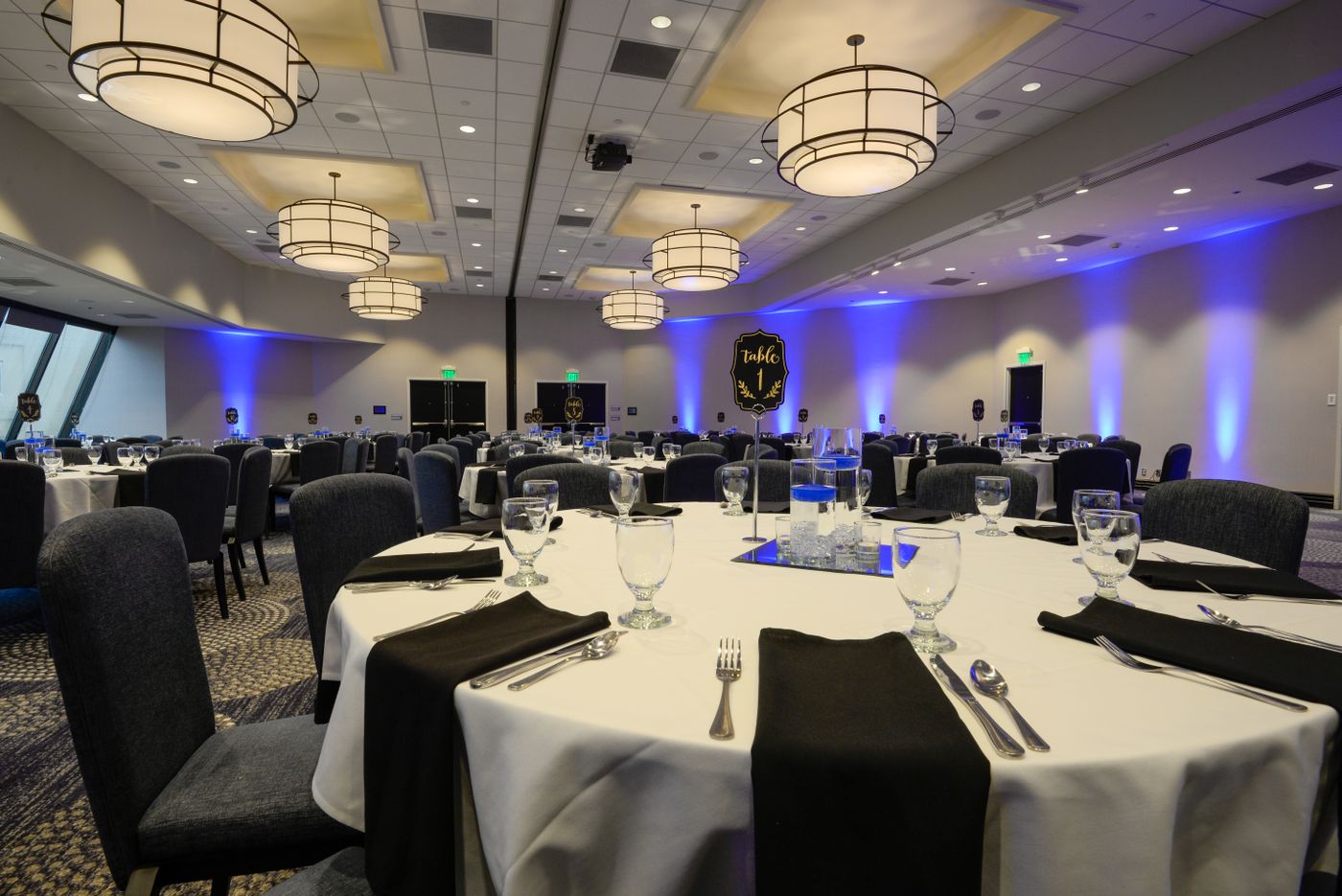 Banquet hall with round tables set for an event reception