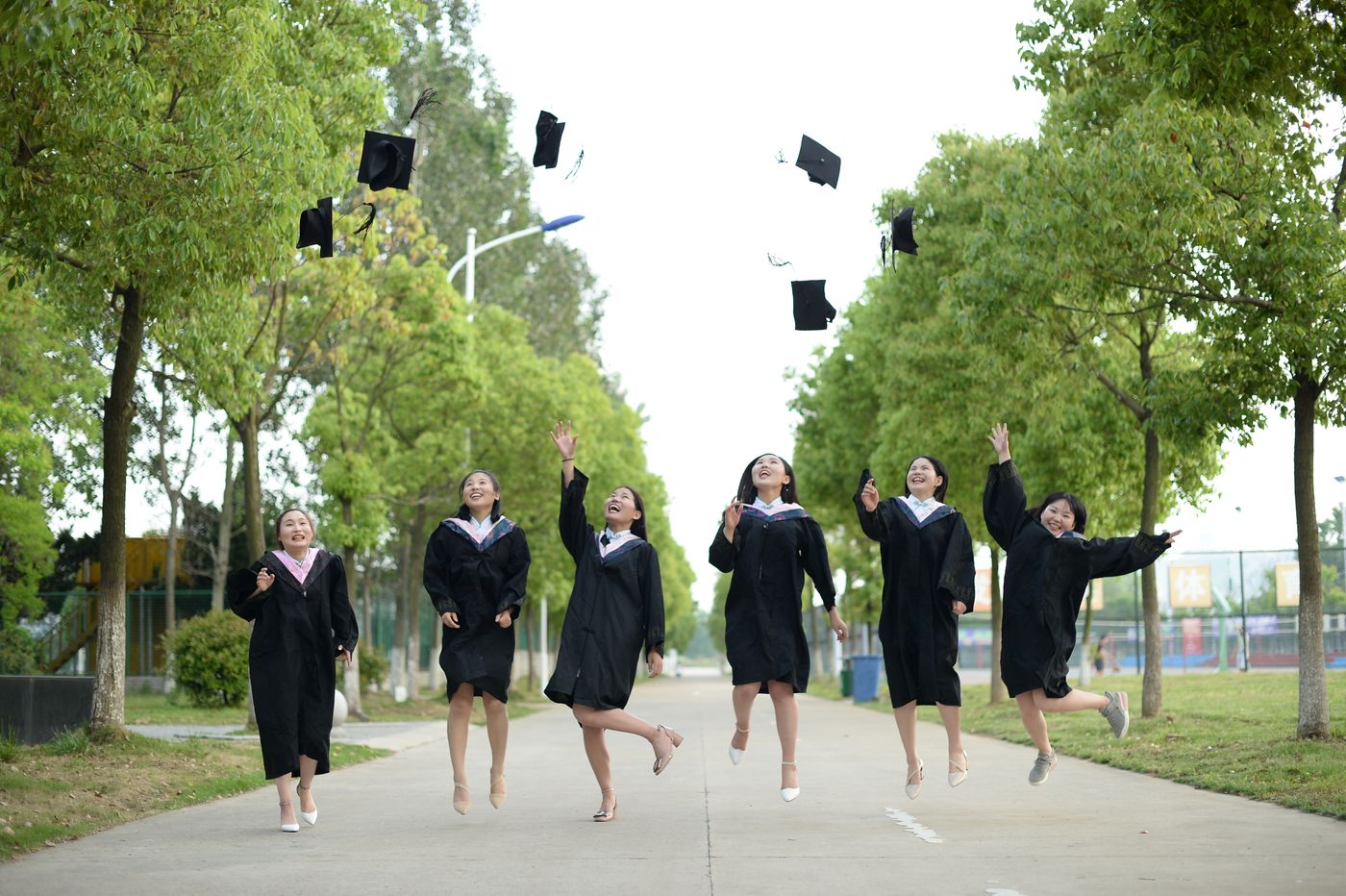 Graduation celebration Costa del Sol Graduates tossing caps in the air at a sunny end-of-year celebration