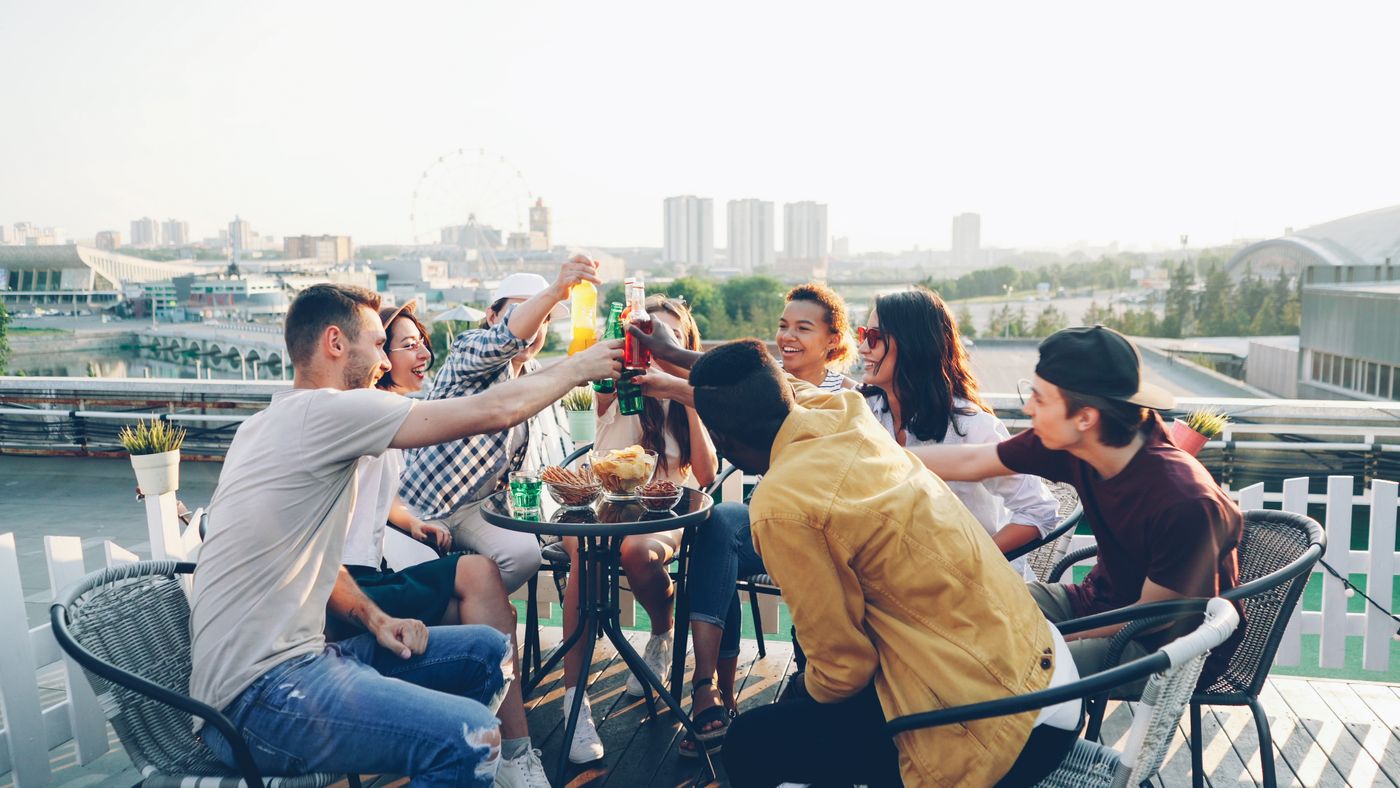 Friends toasting on a terrace during a party in Malaga city